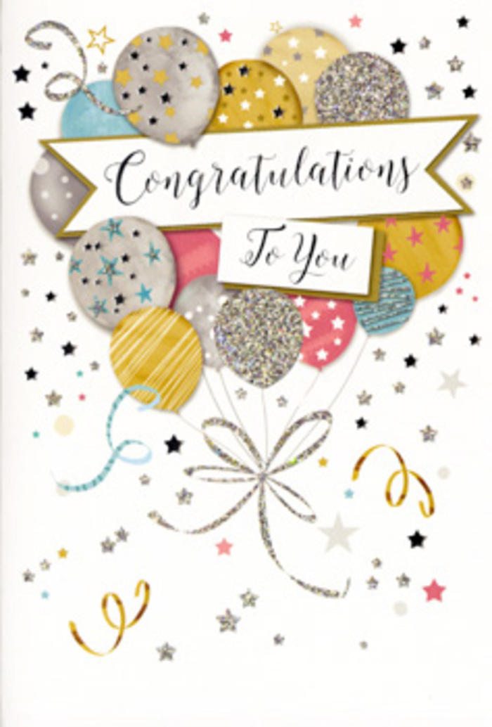 In this photograph, a congratulations card stands neatly upright, captured in soft, even light that lets every festive detail shine. The entire front of the card is an illustration of celebration: a lush cluster of balloons fills the central space, overlapping like a cheerful bouquet, each one round and plump as if filled with helium and ready to drift toward the ceiling of a party in Rush Green. The colour palette is gently luxurious-muted golds and silvers, pale champagne, light blue, blush pink, and soft grey-so nothing feels garish, only elegantly jubilant. Delicate metallic stars, slender stripes, and tiny glittering dots adorn the balloons, giving a sense of texture and sparkle that you can almost feel with your fingertips. From beneath the cluster, flowing gold and silver ribbons twist and curl downwards, sketched with a sense of movement that echoes the loose spirals of curling ribbon we tie around hand-tied bouquets in the workshop near Rush Green's quiet residential streets. Sprinkled throughout the pale background are miniature stars and swirling lines of confetti, as if the card captured the air just after a joyful announcement. Cutting through the centre is a sweeping banner with refined, slightly ornate calligraphy that reads Congratulations To You, the words balanced between formality and heartfelt warmth. The composition feels carefully considered, with the banner anchoring the design while the balloons rise above it like hopes for the future. It is easy to imagine this card nestled beside celebratory flowers-perhaps lilies and roses for a promotion or exam success-delivered to homes around Romford Road and beyond, sharing not just congratulations but an enduring sense of pride, encouragement, and optimism.