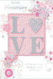 This anniversary card, photographed as though laid on a polished Rush Green sideboard, offers a gentle celebration of enduring romance. At its centre, the word LOVE stands out in softly raised glitter, each letter edged with a delicate shimmer, while the O transforms into a sparkling silver heart that glows against the pastel background. The colour scheme is restrained and tender, blending pastel pinks, silvery greys, and off-white tones, creating a calm, intimate mood much like an evening stroll through nearby parks. Surrounding the central motif, clusters of delicate blooms unfurl in blush and mauve, their watercolor-like petals softened at the edges. Fine, flowing lines sketch out stems, leaves, and curving tendrils, giving the sense that the flowers are drifting gently across the card, similar to petals scattering from a hand-tied bouquet delivered for an anniversary dinner at home. Small flourishes-tiny petals, looping swirls, and subtle butterflies-add movement and grace, evoking the charm of an English spring garden lovingly described by a local florist. Along the top and lower section, the words On Our Anniversary and I love you today and always appear in a refined, script-like font, the letters slim and neatly curved, mirroring the elegant sweep of the floral lines. The card's surface combines smooth paper with slightly embossed, glittery details, inviting the fingertips to wander. Overall, this design feels like a quiet keepsake of shared years in Rush Green: soft as a whisper, visually romantic, and deeply heartfelt without ever being overly ornate.